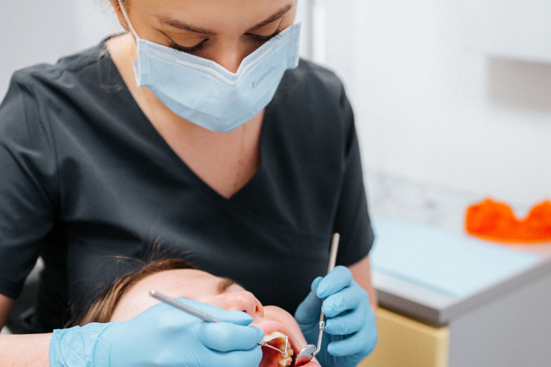 przemiana uśmiechu bez ortodoncji - dentysta i pacjent w trakcie wizyty 